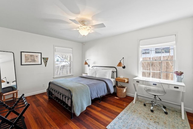 bedroom featuring a ceiling fan, baseboards, and wood finished floors