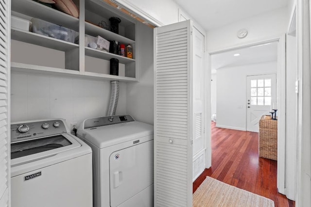 laundry area featuring dark wood-style floors, laundry area, and separate washer and dryer