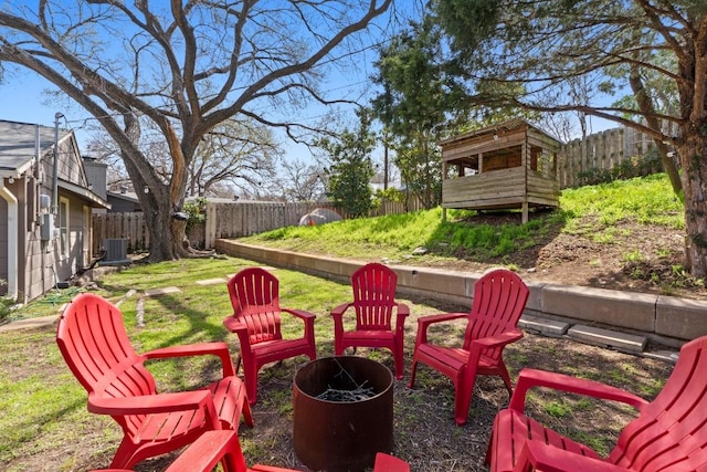 view of patio / terrace featuring central air condition unit, fence private yard, and an outdoor fire pit