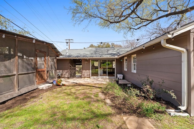 view of yard with a sunroom and a patio area