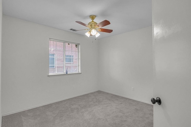 spare room featuring ceiling fan, visible vents, and carpet flooring