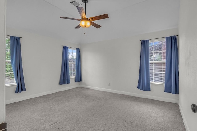 unfurnished room featuring carpet, visible vents, and a healthy amount of sunlight