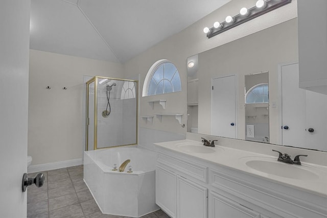 bathroom featuring vaulted ceiling, a stall shower, tile patterned flooring, and a sink