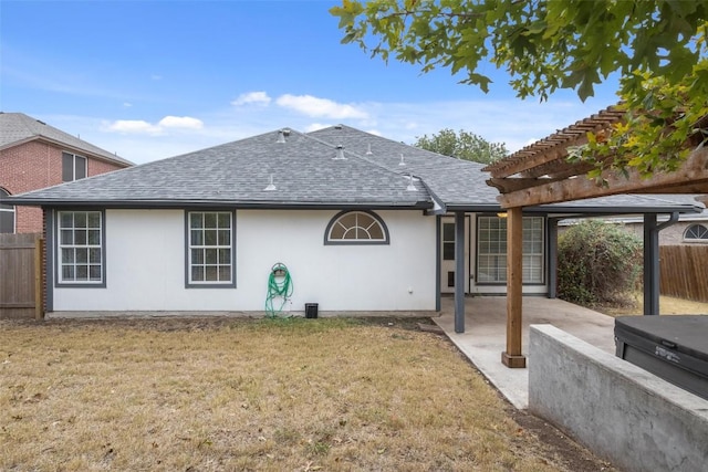 back of house with a shingled roof, fence, a pergola, and a patio