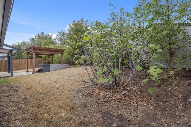 view of yard featuring a patio area, fence, and a pergola