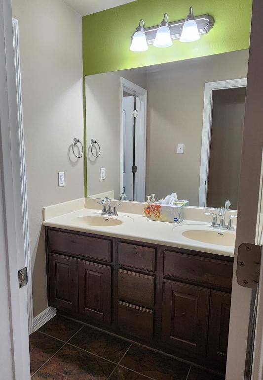 bathroom with tile patterned flooring, double vanity, and a sink