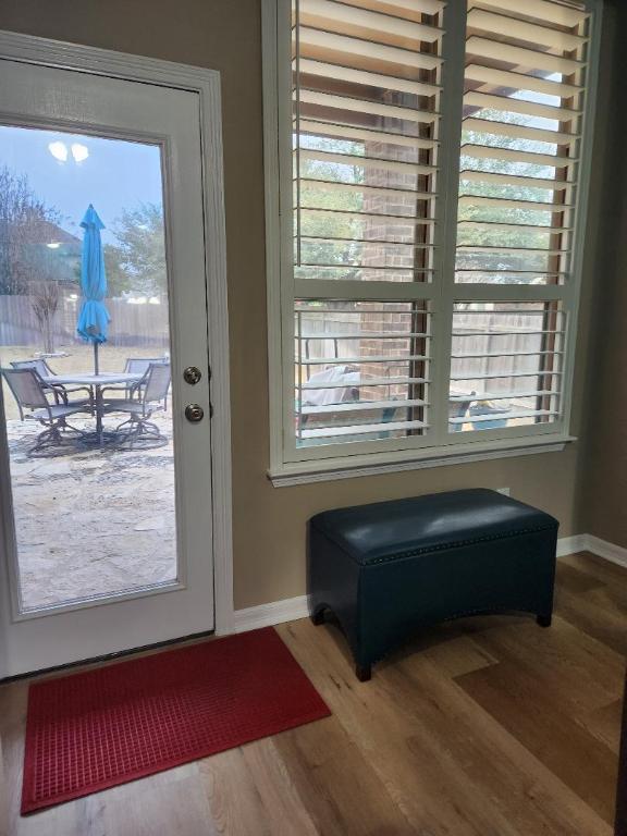 doorway with baseboards and wood finished floors