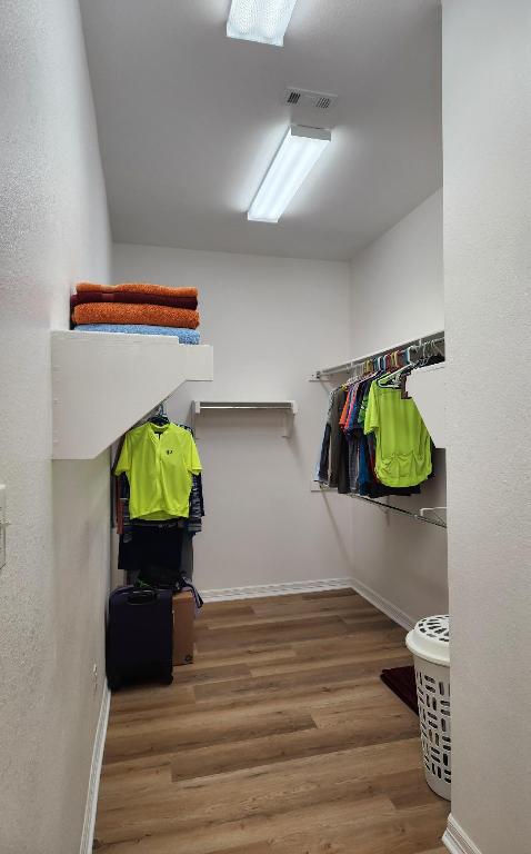 walk in closet featuring visible vents and wood finished floors