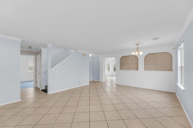 15009 Mossycup Ln, Austin, TX 78724 - unfurnished room featuring a chandelier, arched walkways, stairway, crown molding, and baseboards