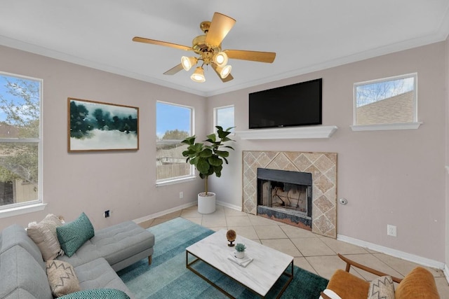 15009 Mossycup Ln, Austin, TX 78724 - living area with tile patterned flooring, plenty of natural light, a tile fireplace, a ceiling fan, and crown molding