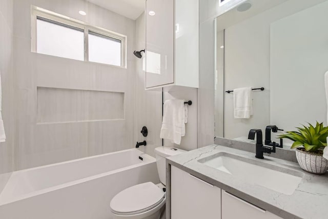 full bathroom featuring tub / shower combination, vanity, and toilet