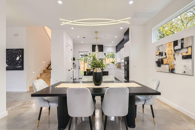 dining space featuring baseboards, visible vents, stairs, concrete flooring, and recessed lighting