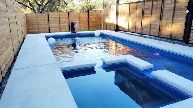 view of swimming pool with a fenced backyard and a hot tub