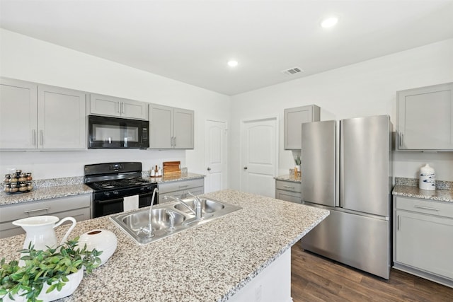 187 Dorchester Dr, Kyle, TX 78640 - kitchen featuring black appliances, gray cabinetry, and recessed lighting