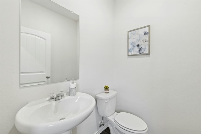 bathroom with toilet and a sink