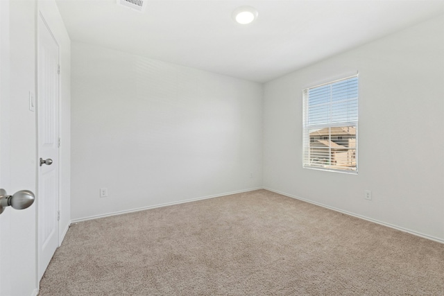 carpeted spare room with visible vents