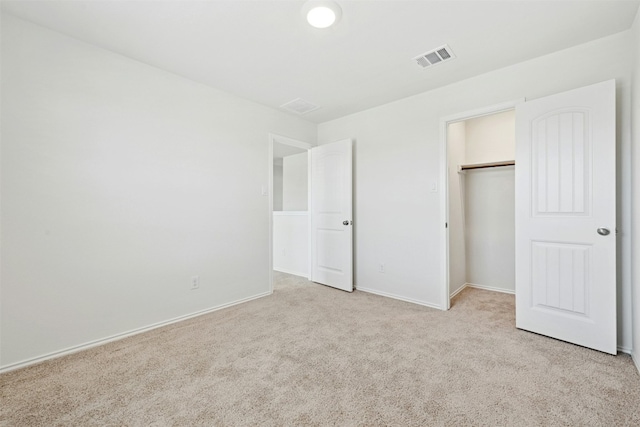 unfurnished bedroom featuring carpet floors, a closet, visible vents, and baseboards