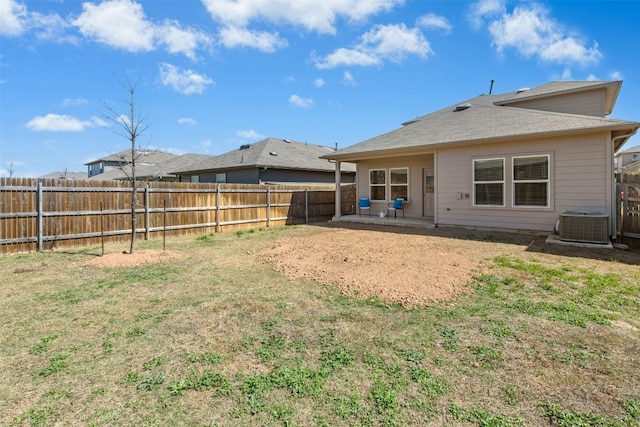 back of property featuring a lawn, a patio area, a fenced backyard, and central air condition unit