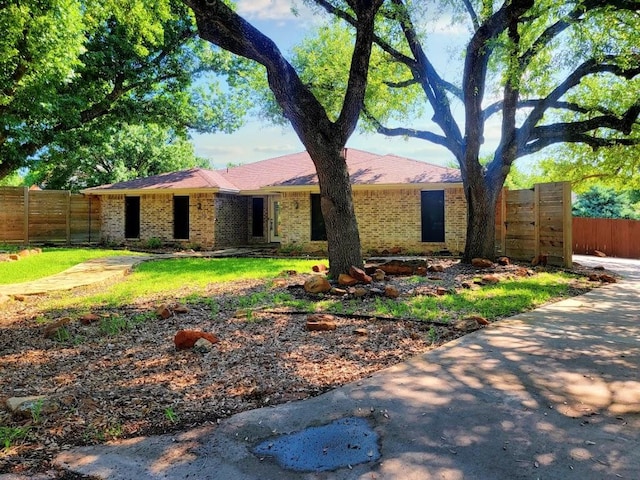 view of front of home with fence and brick siding