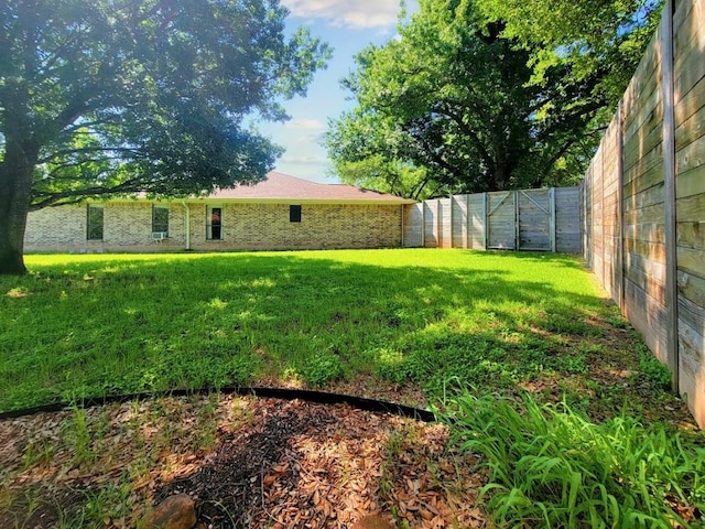 view of yard with a fenced backyard