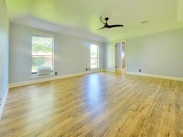 unfurnished room featuring light wood-style floors, visible vents, baseboards, and a ceiling fan