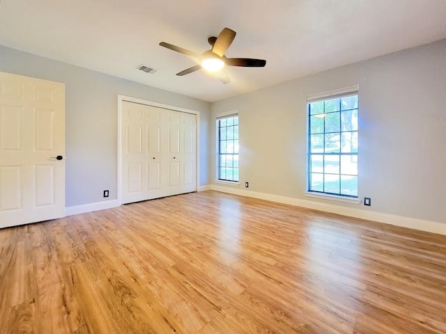 2605 Hilltop St, Round Rock, TX 78681 - unfurnished bedroom featuring light wood-type flooring, multiple windows, and baseboards