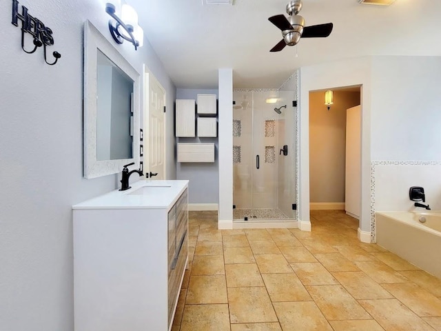 full bathroom featuring a stall shower, baseboards, a ceiling fan, vanity, and a bath