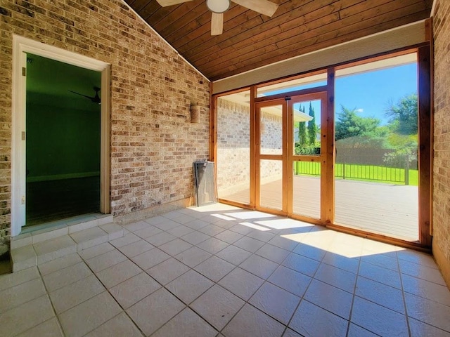 unfurnished sunroom with lofted ceiling, wooden ceiling, and a ceiling fan