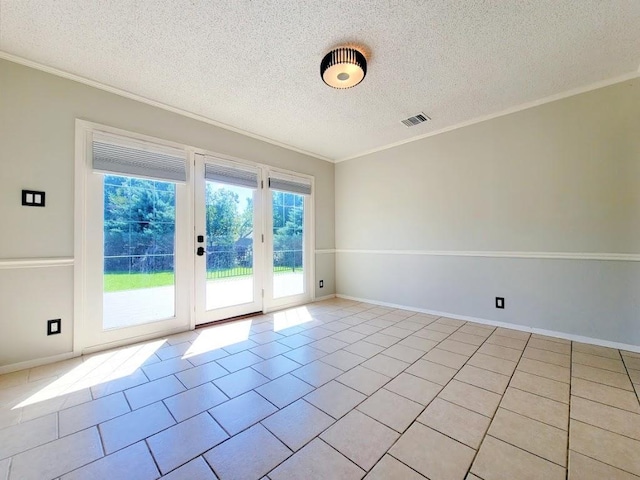 spare room featuring light tile patterned floors, a textured ceiling, visible vents, and crown molding