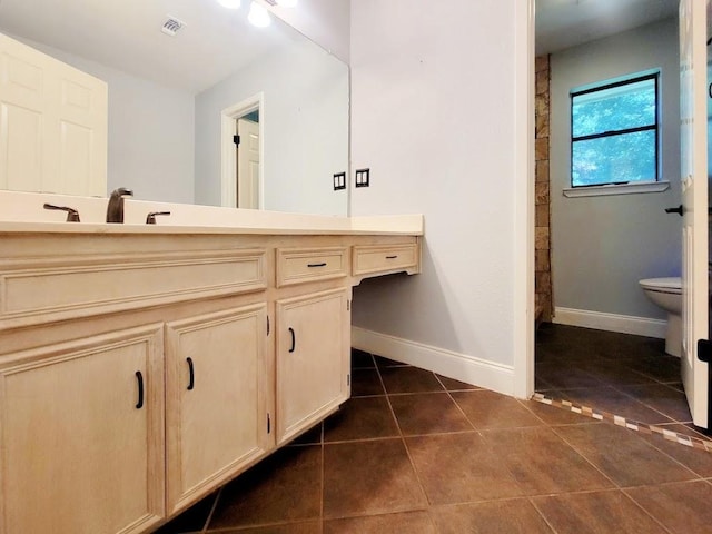 bathroom featuring visible vents, baseboards, toilet, tile patterned flooring, and vanity