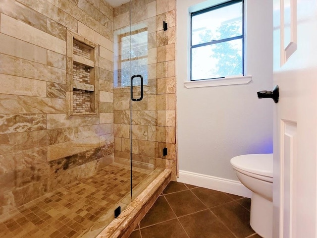 2605 Hilltop St, Round Rock, TX 78681 - full bathroom with tile patterned floors, a shower stall, toilet, and baseboards