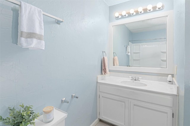 bathroom with a shower and vanity