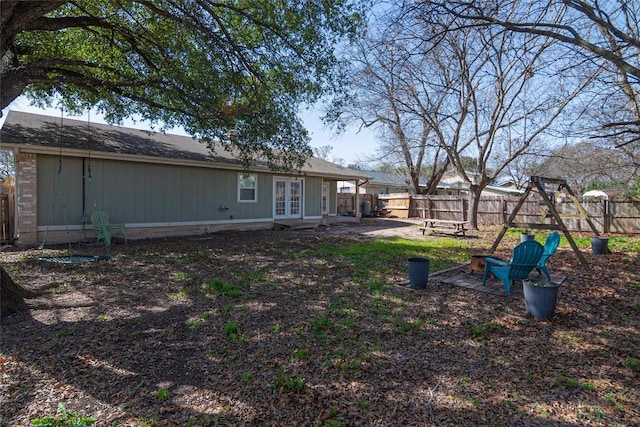 view of yard featuring french doors, a patio area, and fence