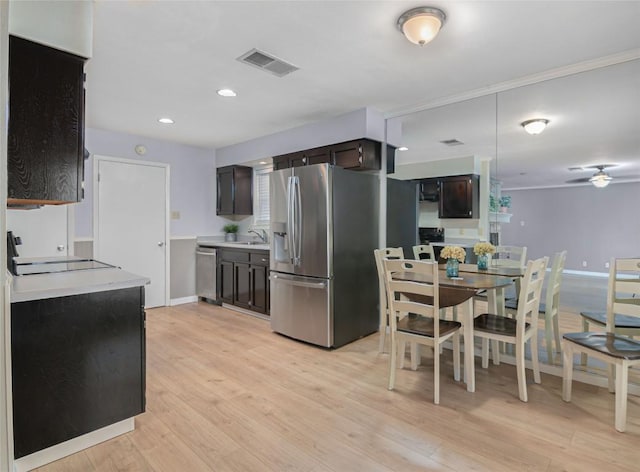 kitchen with stainless steel appliances, a ceiling fan, dark brown cabinets, light countertops, and light wood-type flooring