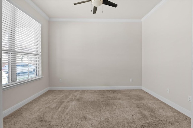 spare room featuring light carpet, ceiling fan, ornamental molding, and baseboards