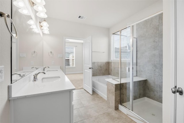 bathroom with plenty of natural light, visible vents, and a sink