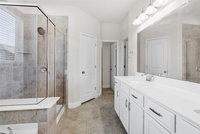 full bath with a shower stall, baseboards, and vanity