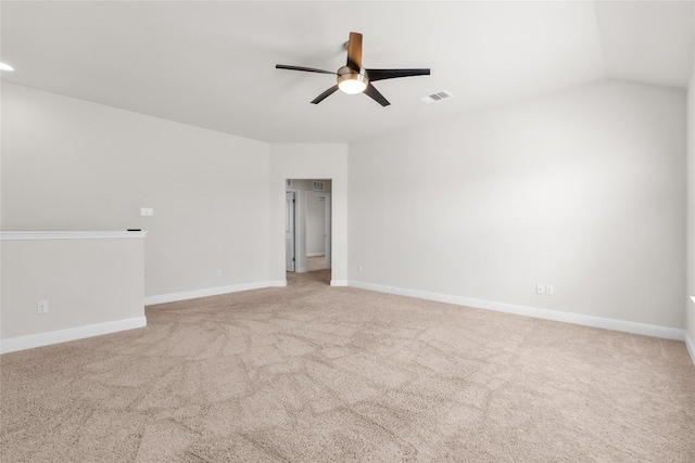 carpeted empty room featuring baseboards, visible vents, and ceiling fan