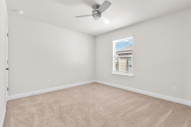 unfurnished room with ceiling fan, carpet, and baseboards