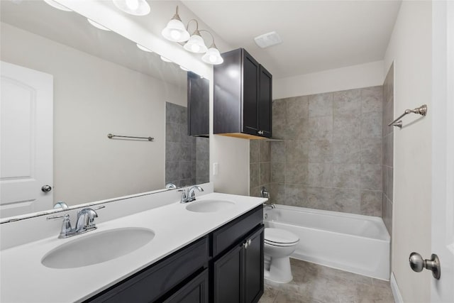 bathroom featuring toilet, double vanity, and a sink