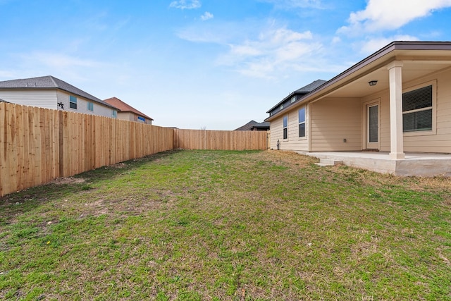 view of yard with a patio area and a fenced backyard