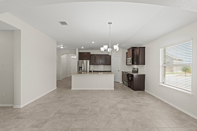 kitchen featuring a notable chandelier, stainless steel appliances, visible vents, dark brown cabinets, and tasteful backsplash