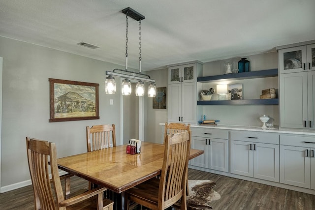 dining space with dark wood-style floors and visible vents