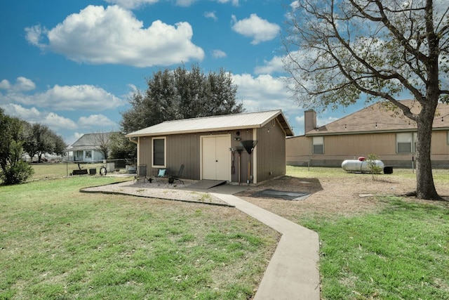 view of outdoor structure with an outbuilding and fence