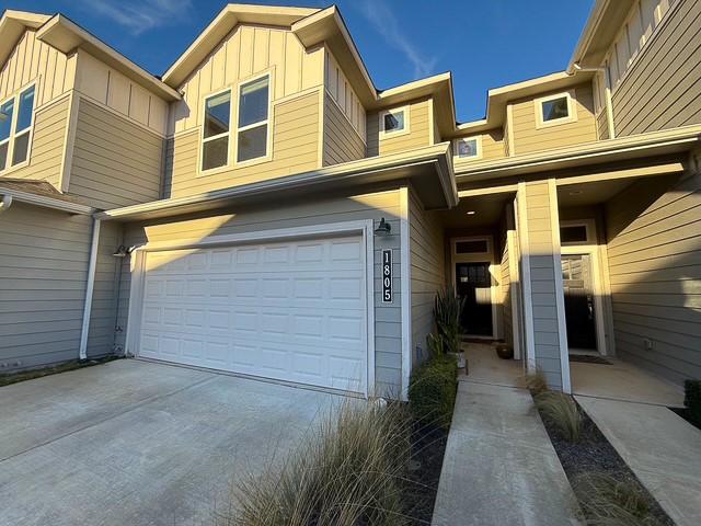 view of front of property with a garage, driveway, and board and batten siding