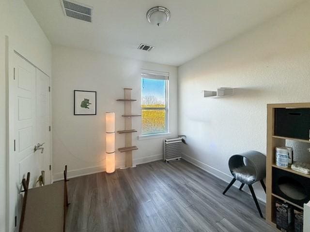 home office featuring visible vents, baseboards, and wood finished floors