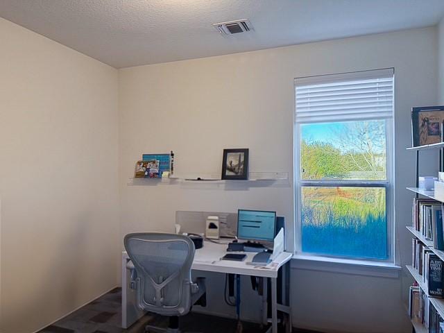 office featuring visible vents and a textured ceiling