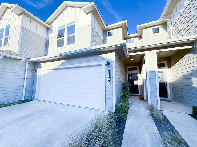 1805 Roseburg Dr, Austin, TX 78754 - exterior space featuring driveway, an attached garage, and board and batten siding