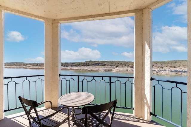 balcony featuring a water view