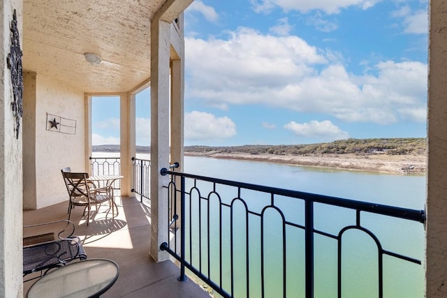 balcony featuring a water view